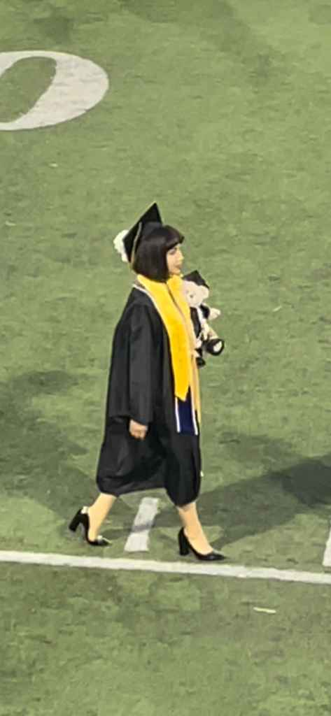 Graduate Nayli J. in cap and gown