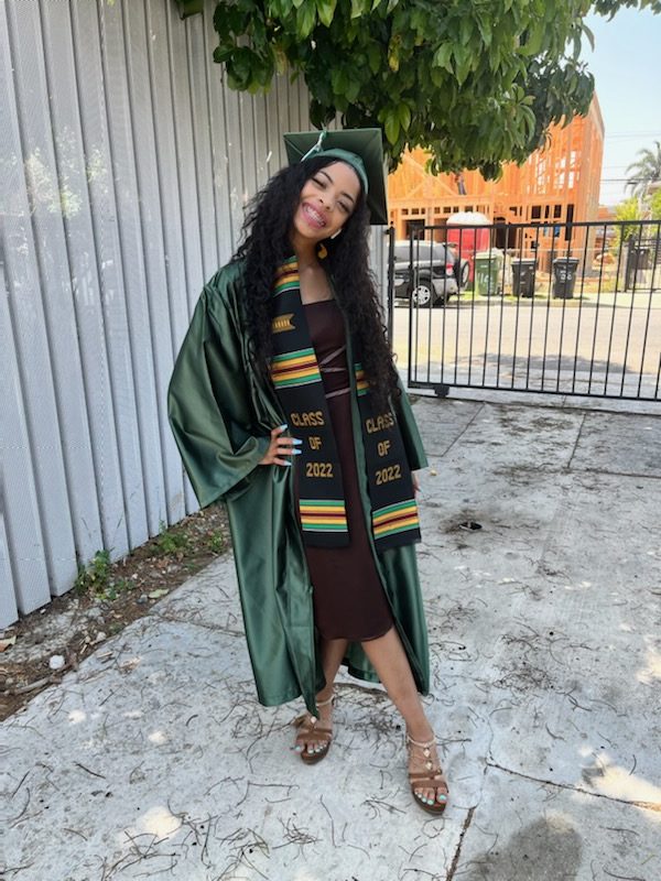 Graduate Soraya K. in green cap and gown