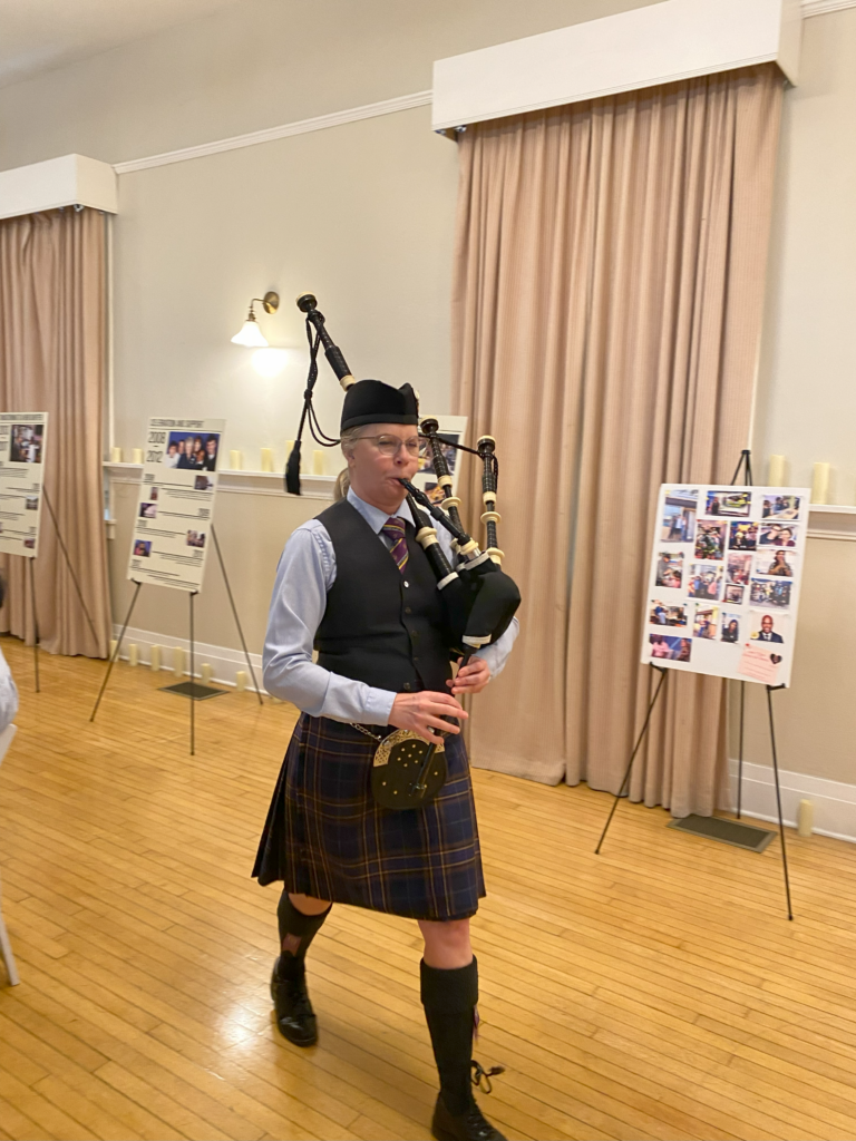Bag piper plays music in celebration of Catherine Meek's contributions to School on Wheels